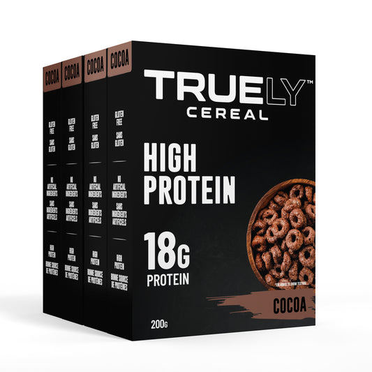 Four boxes of Truely High Protein Cocoa cereal arranged side by side with the front box prominently displayed. The packaging is black with white and brown text and graphics indicating the product is a high protein cereal with 18g of protein per serving.